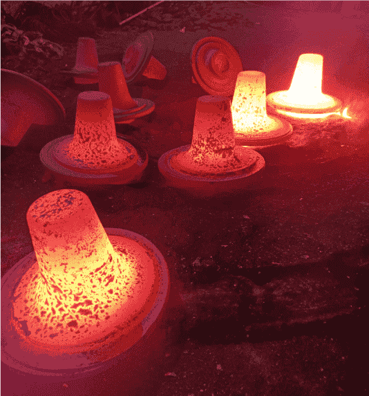 Glowing hot metal castings cooling.