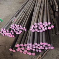 Stacked metal rods with pink markings.